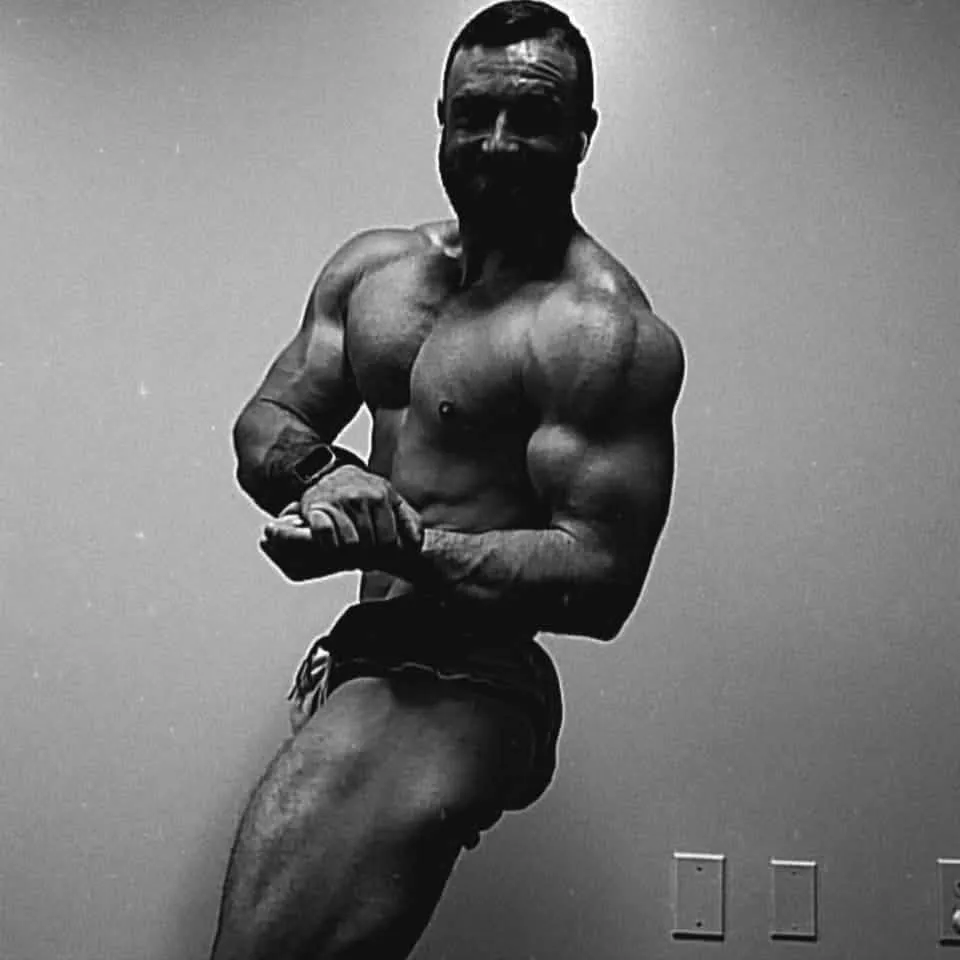 Black and white photo of Brandon Manning hitting a side chest pose