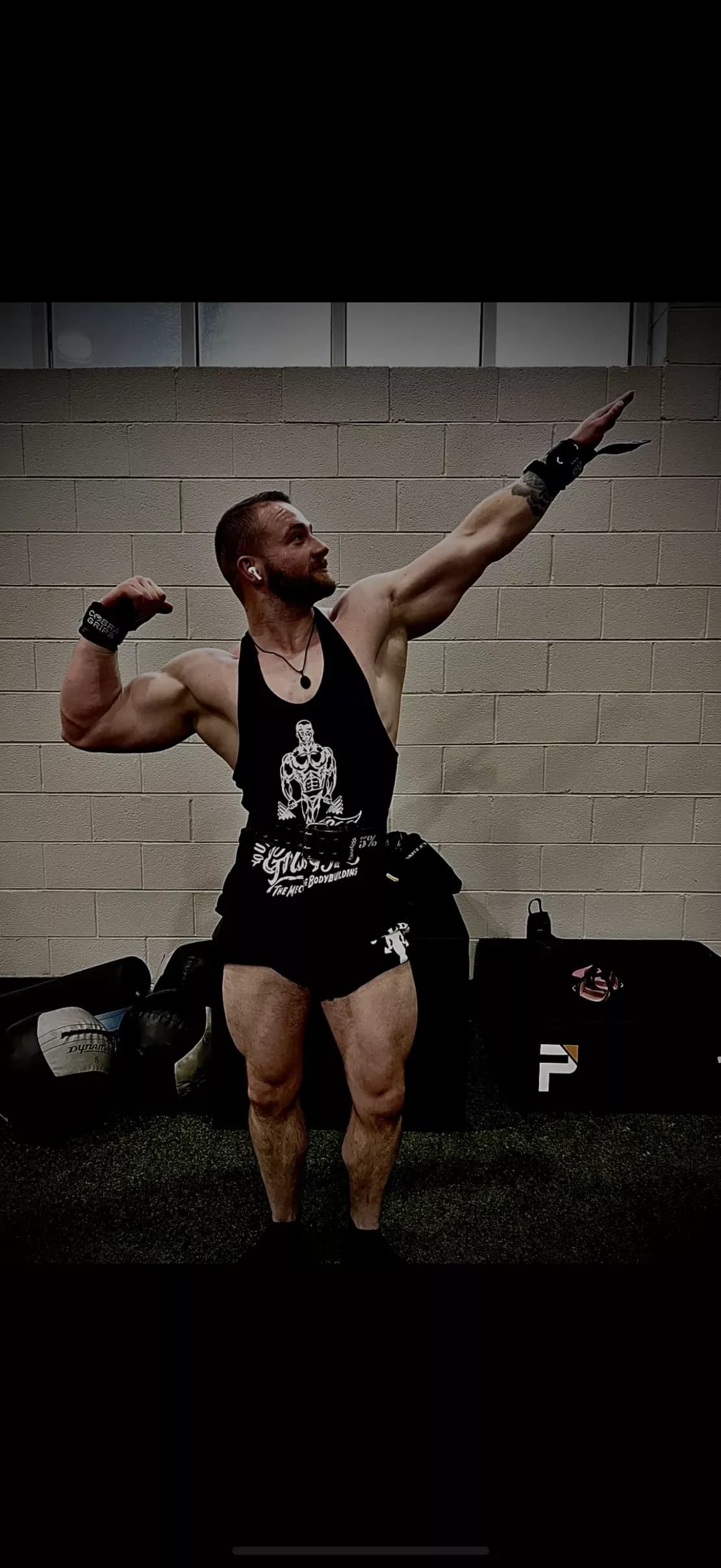 Brandon Manning striking a pose in the gym, one arm raised and the other flexed